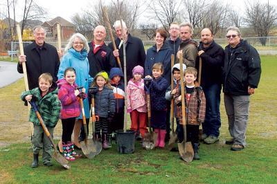 group of volunteers with gardening shovels